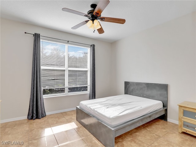 tiled bedroom featuring ceiling fan