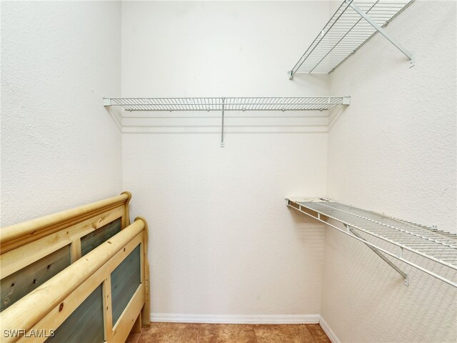 spacious closet featuring tile patterned floors