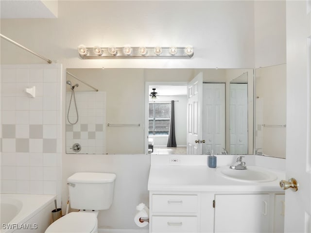 full bathroom with tiled shower / bath, vanity, and toilet