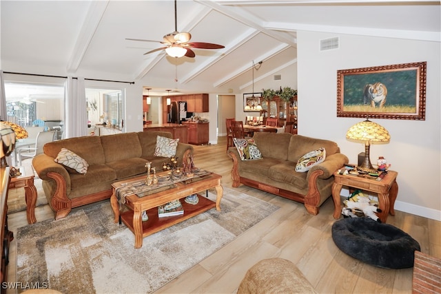 living room featuring vaulted ceiling with beams, light wood-type flooring, and ceiling fan