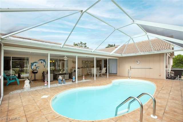 view of swimming pool featuring a patio, a lanai, and ceiling fan