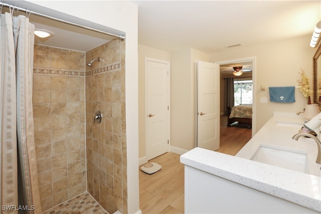 bathroom featuring vanity, hardwood / wood-style floors, ceiling fan, and walk in shower