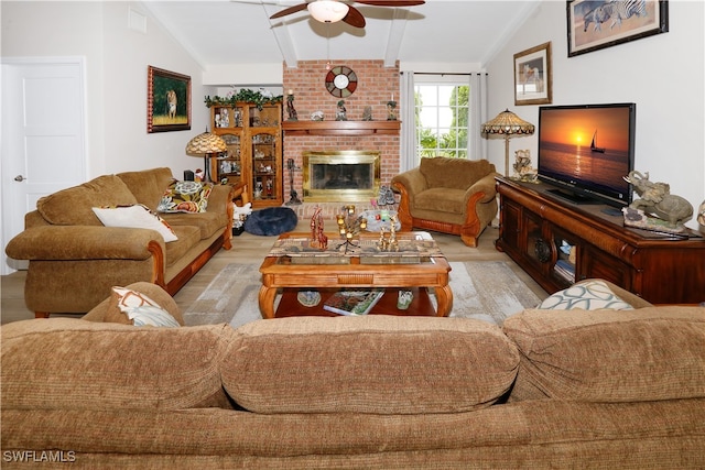 living room featuring light hardwood / wood-style floors, lofted ceiling, a fireplace, and ceiling fan