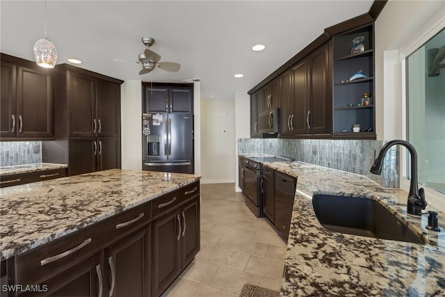 kitchen with dark brown cabinets, stainless steel appliances, sink, and backsplash