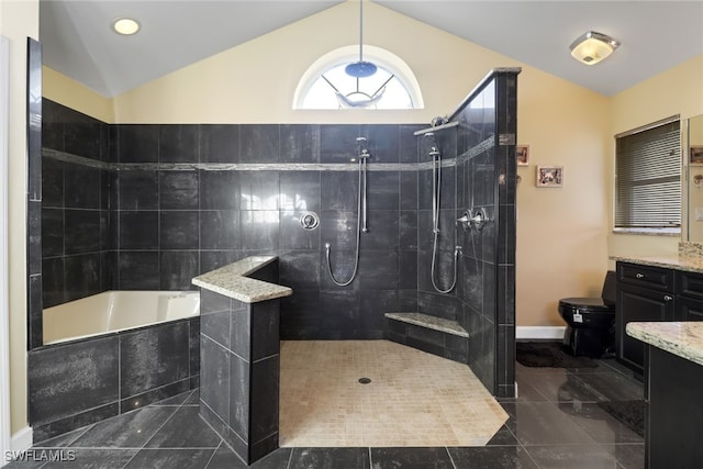 bathroom featuring vanity, plus walk in shower, tile patterned floors, and vaulted ceiling