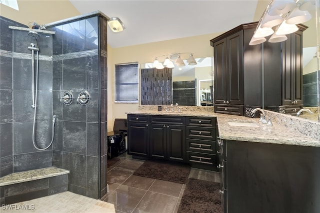 bathroom featuring vanity, a tile shower, and tile patterned floors