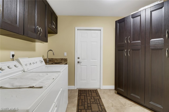 clothes washing area featuring cabinets, light tile patterned flooring, sink, and washer and clothes dryer