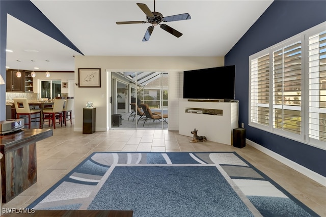 tiled living room featuring vaulted ceiling and ceiling fan