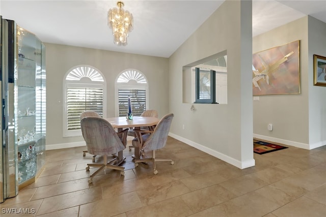 dining space featuring an inviting chandelier and lofted ceiling