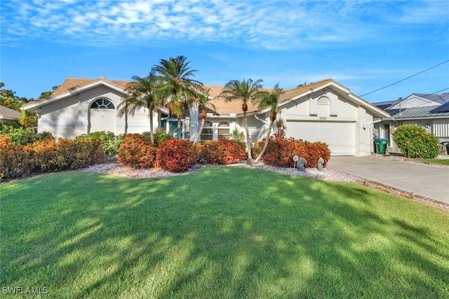 view of front of home with a front yard and a garage