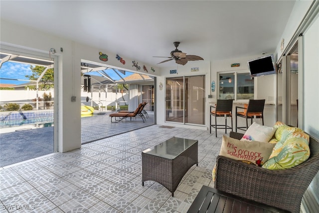 view of patio / terrace with ceiling fan, a lanai, a fenced in pool, and outdoor lounge area