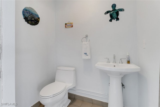 bathroom featuring toilet and tile patterned flooring