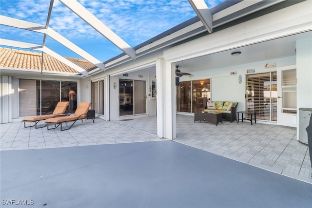 view of patio / terrace featuring ceiling fan and a lanai