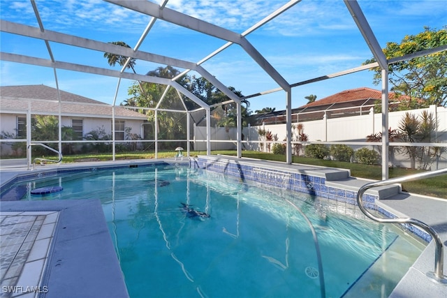 view of swimming pool featuring a patio area and glass enclosure