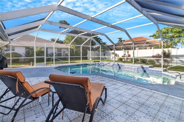 2822 SE 22nd Pl, Cape Coral, FL 33904 - view of swimming pool featuring a fenced in pool, fence, glass enclosure, and a patio area