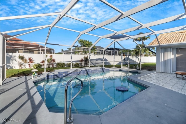 view of swimming pool featuring a patio area and a lanai