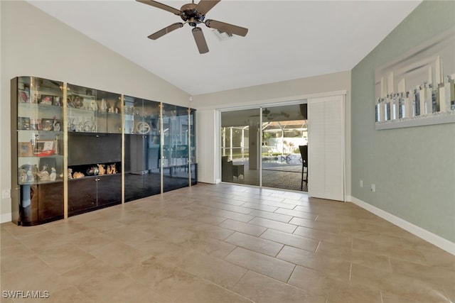 tiled spare room with ceiling fan and lofted ceiling