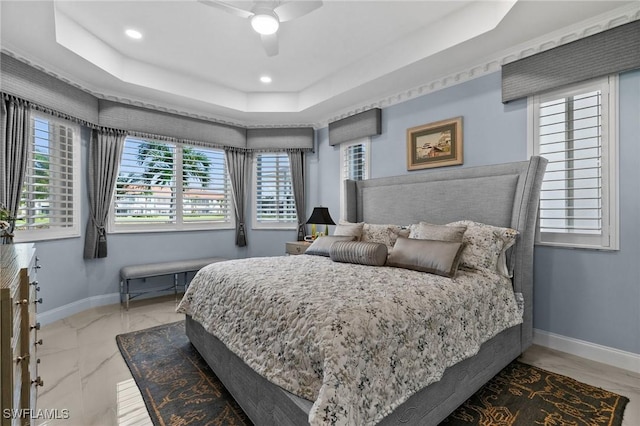 bedroom featuring a tray ceiling and ceiling fan