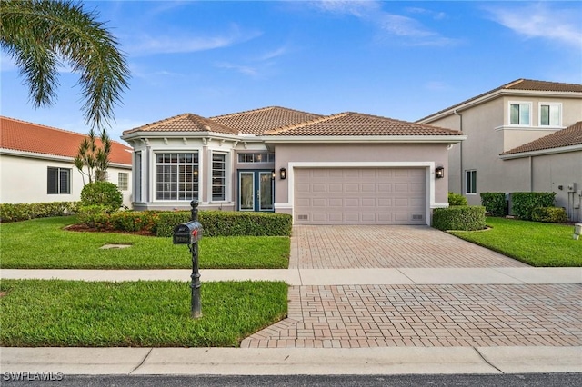 mediterranean / spanish-style home with a garage and a front yard