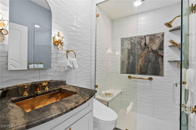 bathroom featuring vanity, a shower with shower door, and toilet