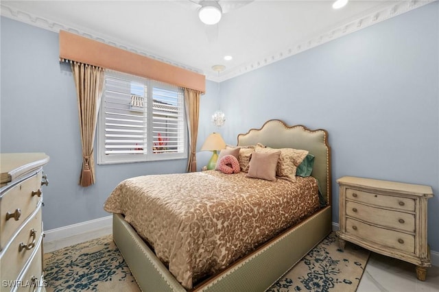 bedroom with ceiling fan, light tile patterned floors, and crown molding