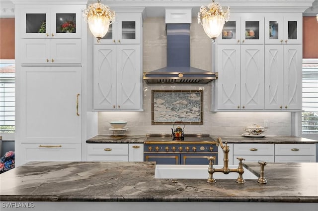 kitchen featuring decorative light fixtures, white cabinetry, tasteful backsplash, and wall chimney exhaust hood