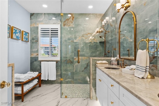 bathroom featuring a tile shower, vanity, and tile walls