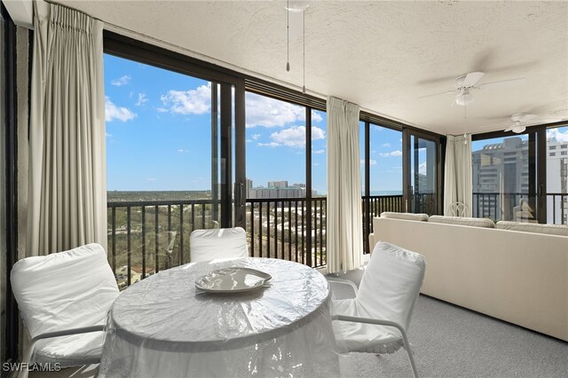 sunroom featuring carpet and plenty of natural light