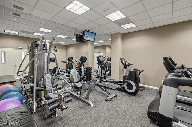 workout area featuring a paneled ceiling and carpet flooring