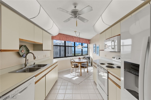 kitchen featuring a sink, white appliances, light tile patterned flooring, ceiling fan, and light countertops