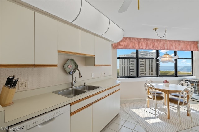 kitchen with sink, white cabinetry, hanging light fixtures, and dishwasher