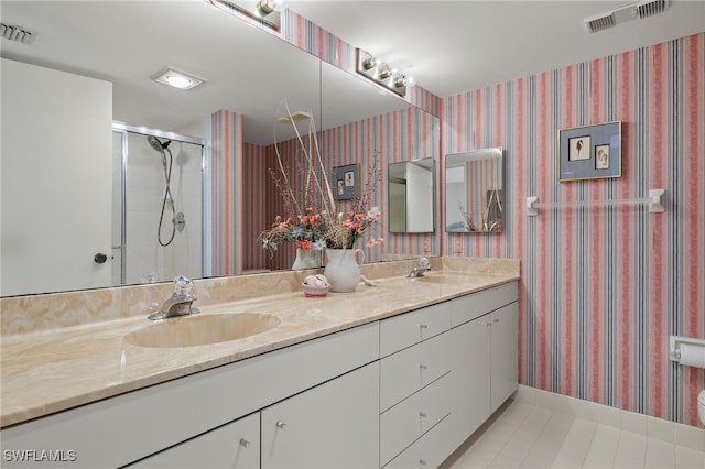 bathroom with a stall shower, visible vents, a sink, and double vanity