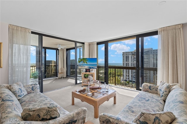 living room featuring light carpet, a wealth of natural light, and floor to ceiling windows