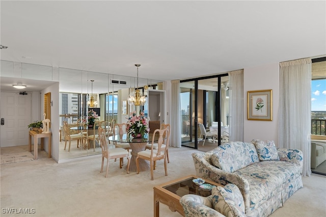 living area with light colored carpet, visible vents, and a chandelier