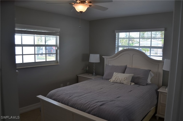 bedroom featuring multiple windows and ceiling fan