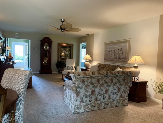 carpeted living room featuring ceiling fan