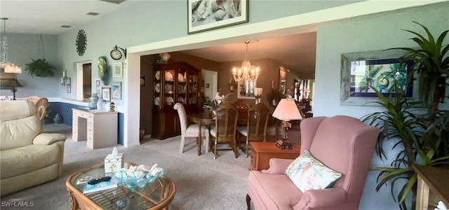 living room with carpet floors and a chandelier