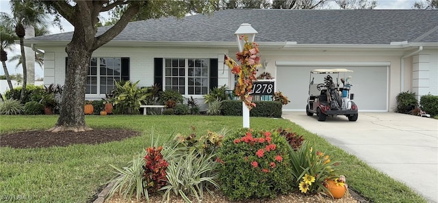 single story home featuring a front yard and a garage