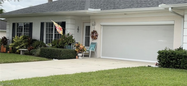 entrance to property with a yard and a garage