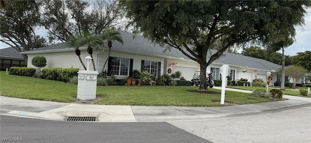 view of front of home with a front lawn and a garage