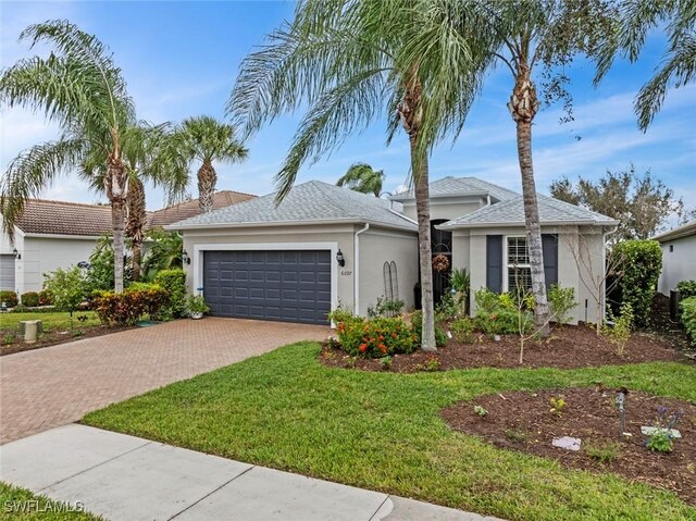 ranch-style home with a front yard and a garage