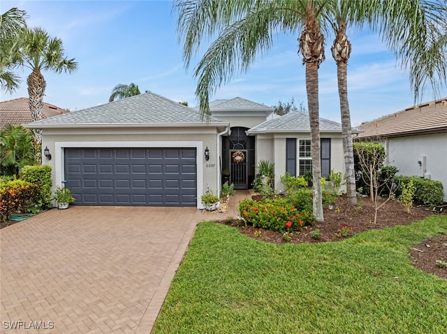 single story home with a front yard and a garage