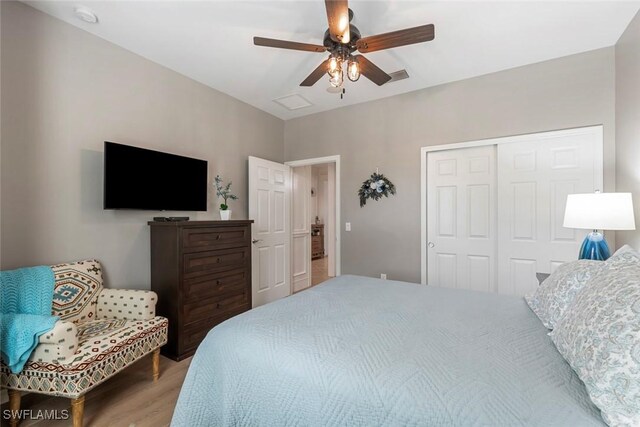 bedroom with a closet, wood-type flooring, and ceiling fan