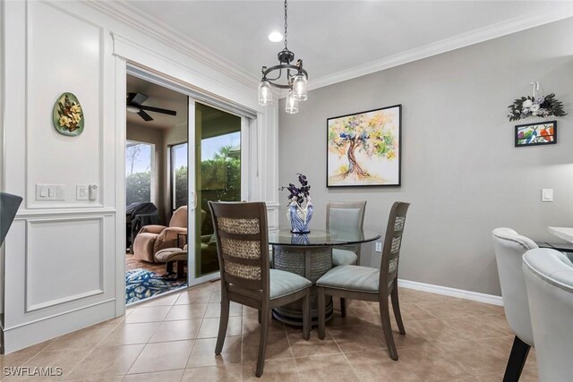 dining space featuring crown molding, ceiling fan with notable chandelier, and light tile patterned floors