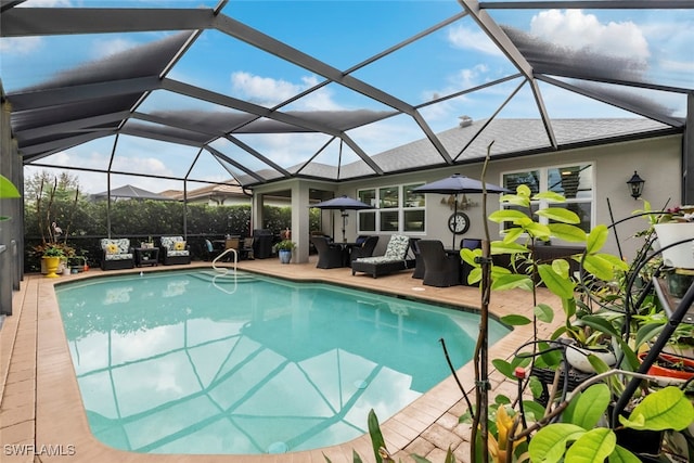 view of pool with a patio and a lanai