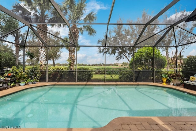 view of pool with glass enclosure