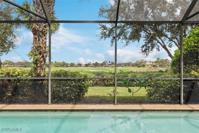 view of swimming pool featuring a lanai