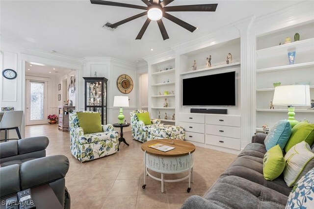 living room featuring crown molding, light tile patterned flooring, built in features, and ceiling fan