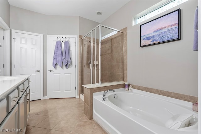 bathroom featuring vanity, plus walk in shower, and tile patterned flooring