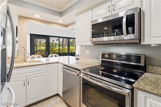 kitchen with white cabinetry, light stone countertops, and stainless steel appliances